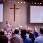 Sunday worship music hymns hands raised